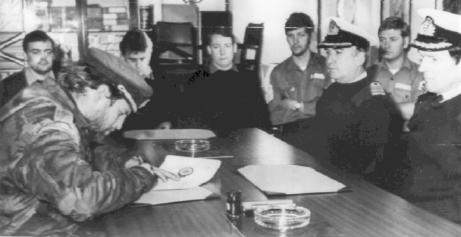 Alfredo Astiz signing the surrender document on board the British HMS Plymouth